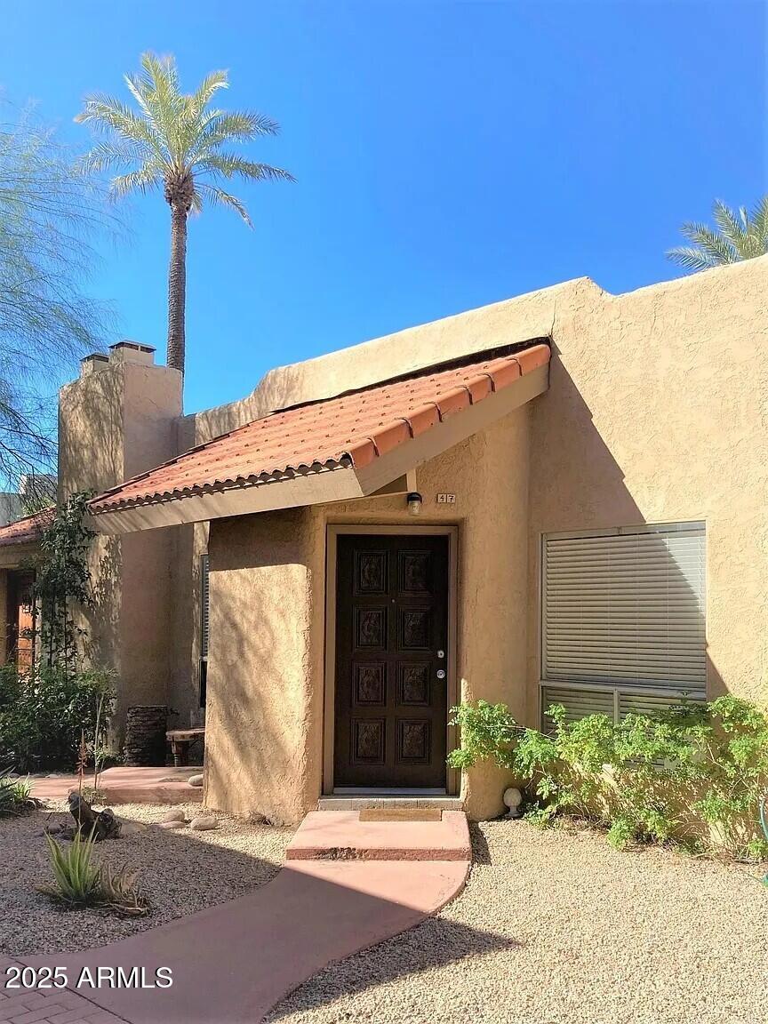 4540 North 44th Street, Unit 47 Phoenix, AZ 85018 - Photo 8 of 16 a front view of a house with a yard