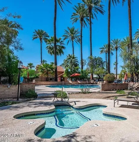 a view of a swimming pool and trees in the background