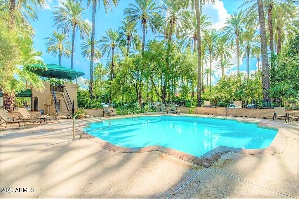 4540 North 44th Street, Unit 47 Phoenix, AZ 85018 - Photo 10 of 16 a view of a swimming pool and trees in the background