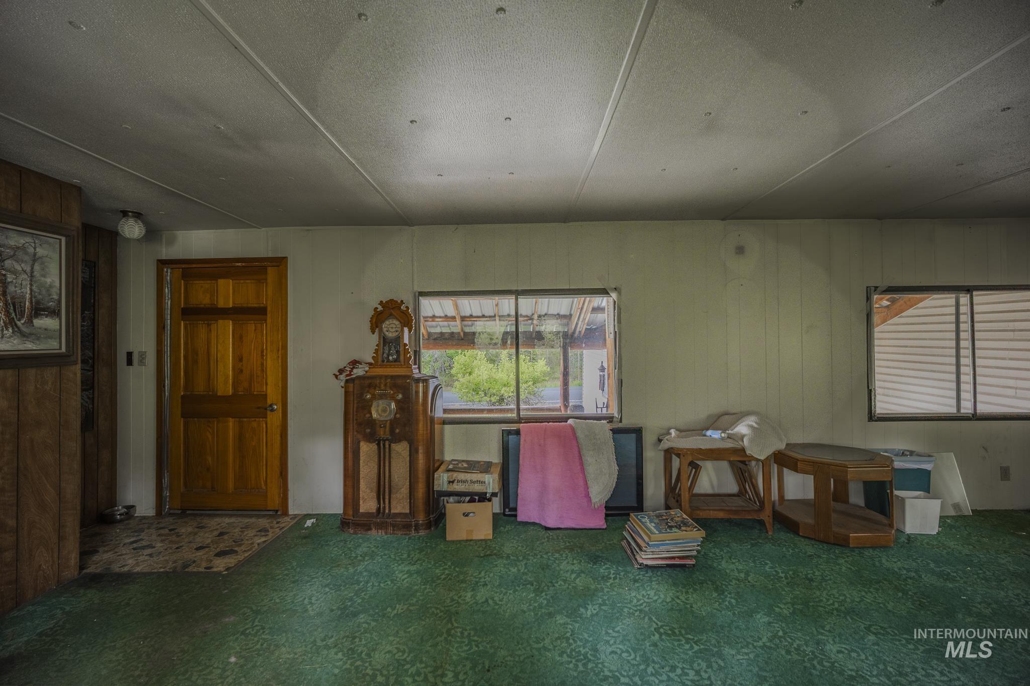 140 Ridgeway Drive Elk City, ID 83525 - Photo 19 of 47 Misc room with healthy amount of natural light and wood walls