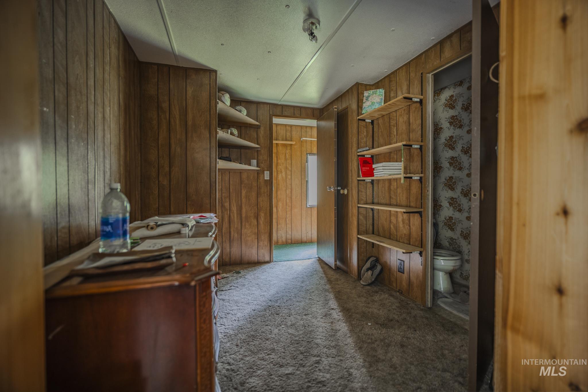 140 Ridgeway Drive Elk City, ID 83525 - Photo 22 of 47 Home office featuring carpet floors and wooden walls