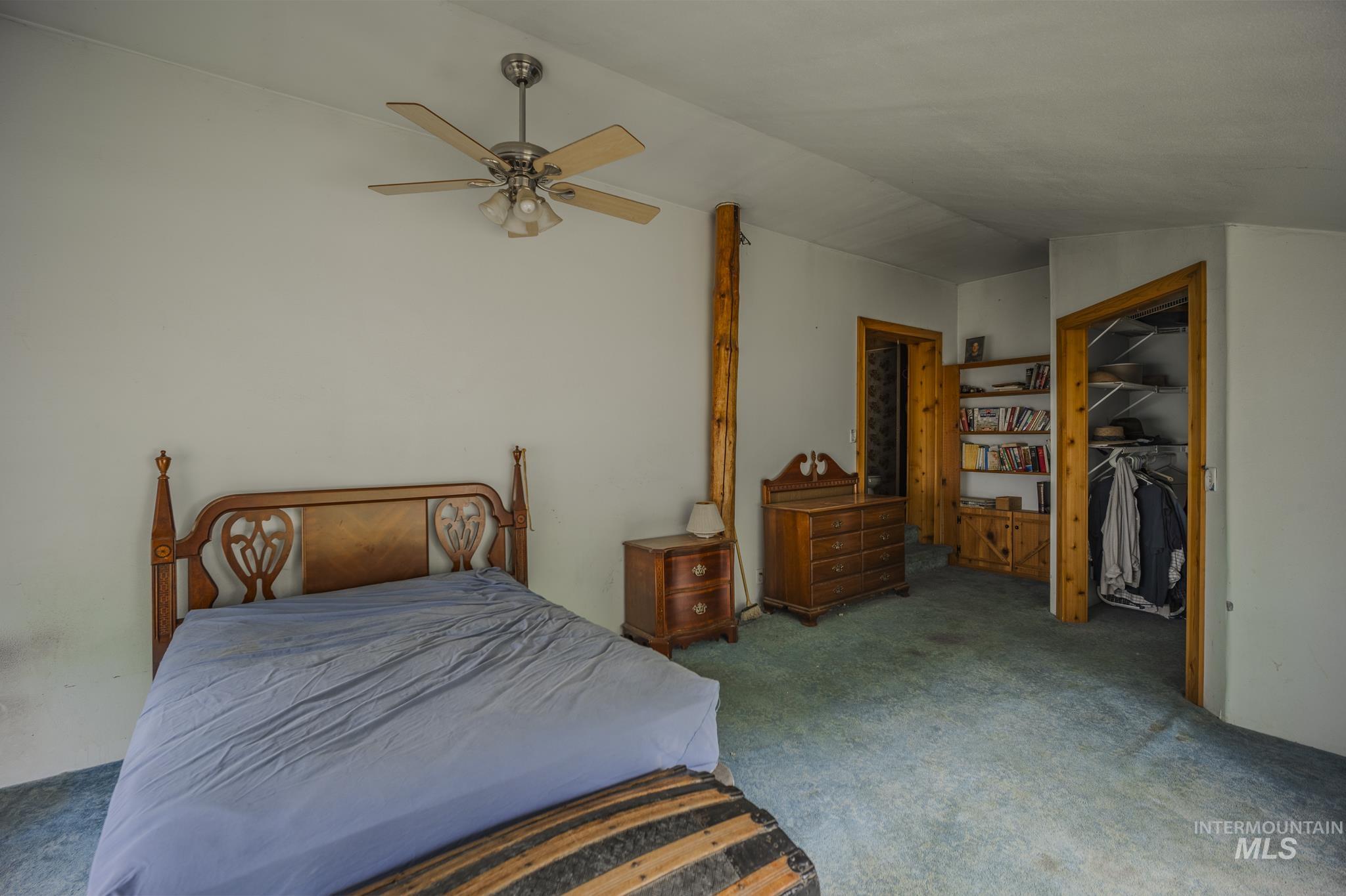 140 Ridgeway Drive Elk City, ID 83525 - Photo 24 of 47 Bedroom featuring carpet, ceiling fan, lofted ceiling, and a walk in closet