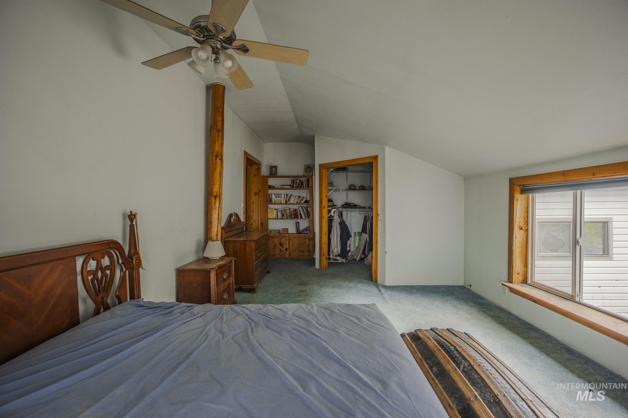 140 Ridgeway Drive Elk City, ID 83525 - Photo 25 of 47 Carpeted bedroom featuring lofted ceiling and a ceiling fan
