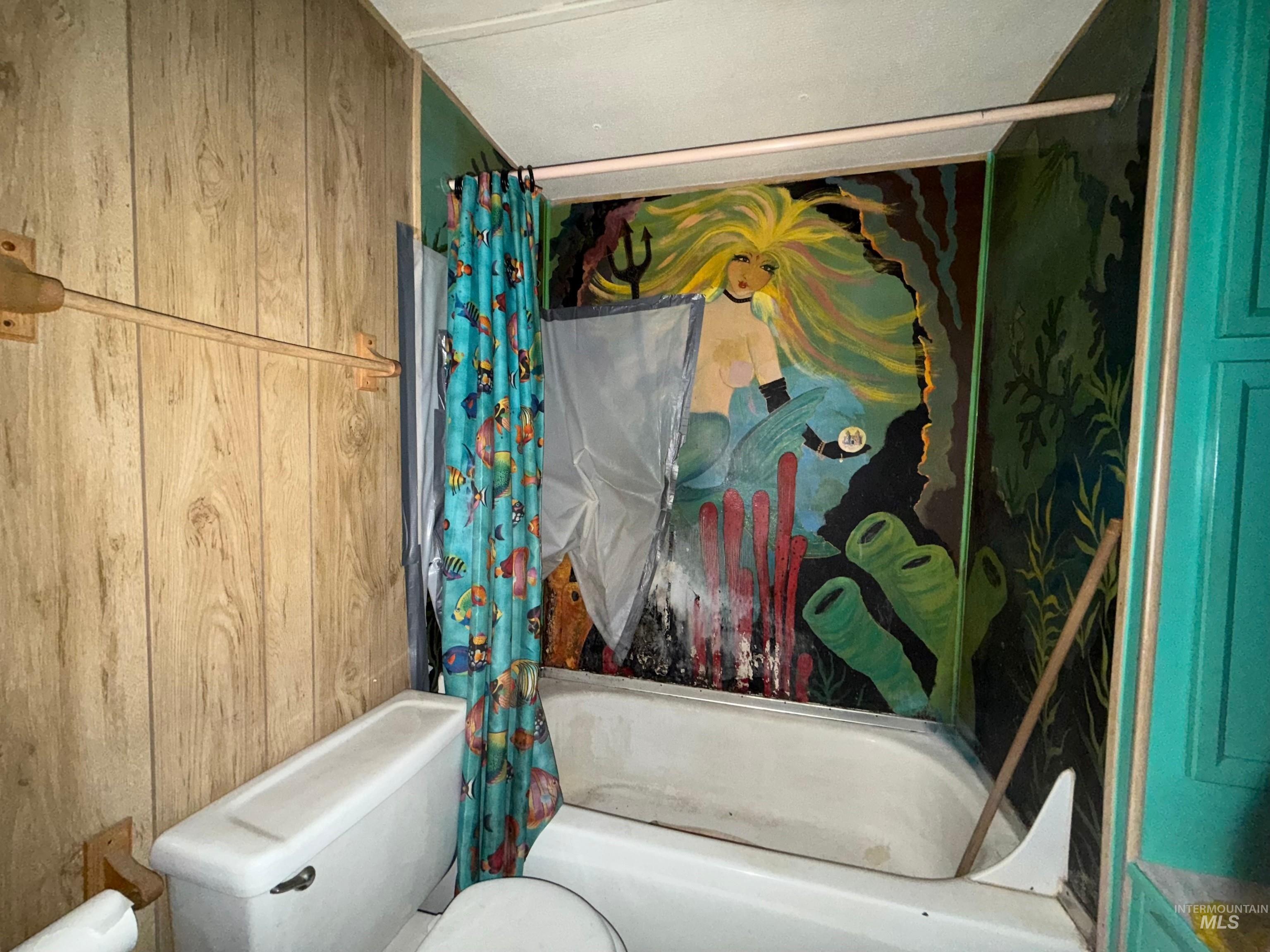 140 Ridgeway Drive Elk City, ID 83525 - Photo 28 of 47 Bathroom featuring wooden walls and shower / tub combo