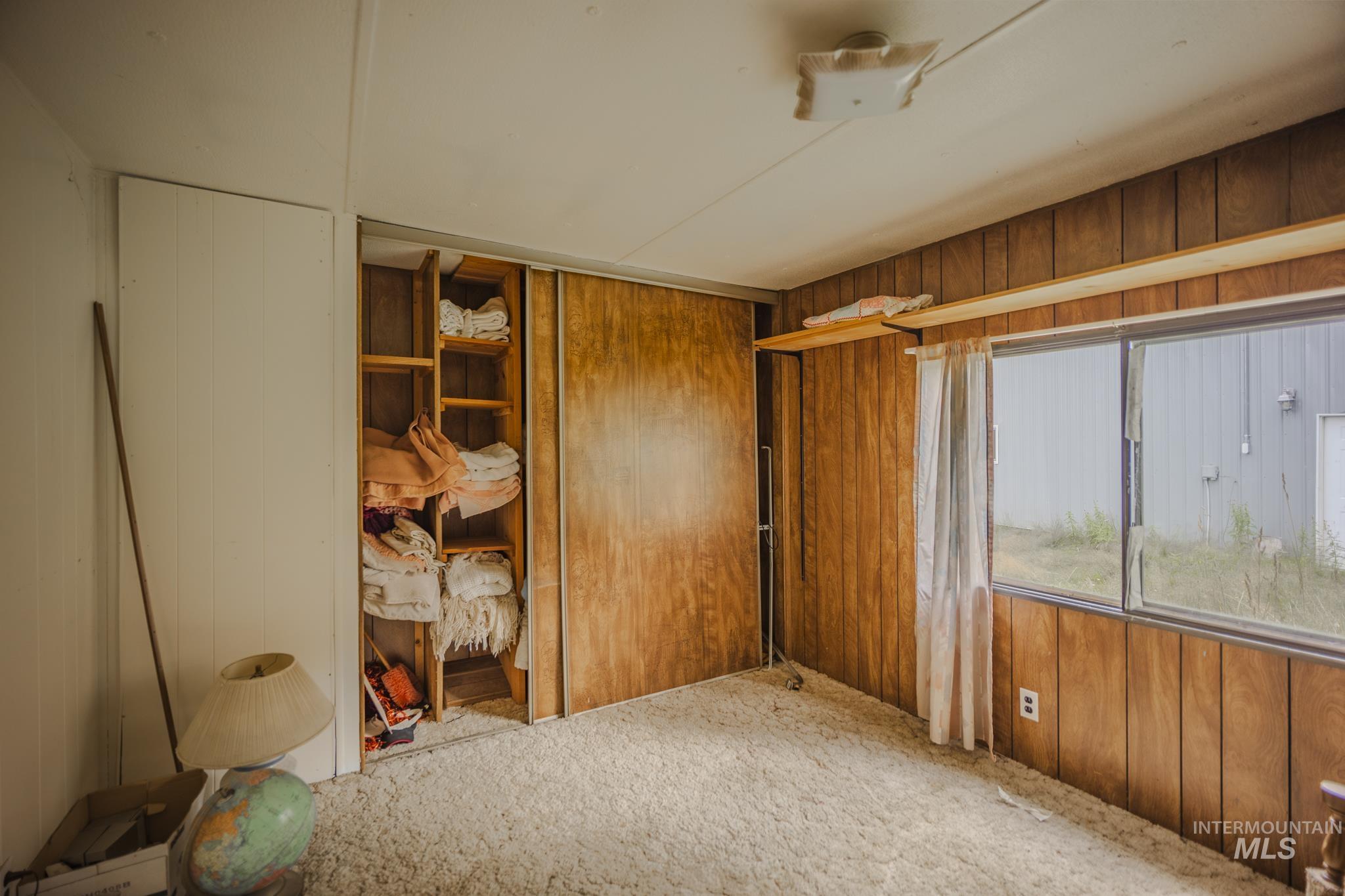 140 Ridgeway Drive Elk City, ID 83525 - Photo 29 of 47 Unfurnished room featuring wood walls and carpet