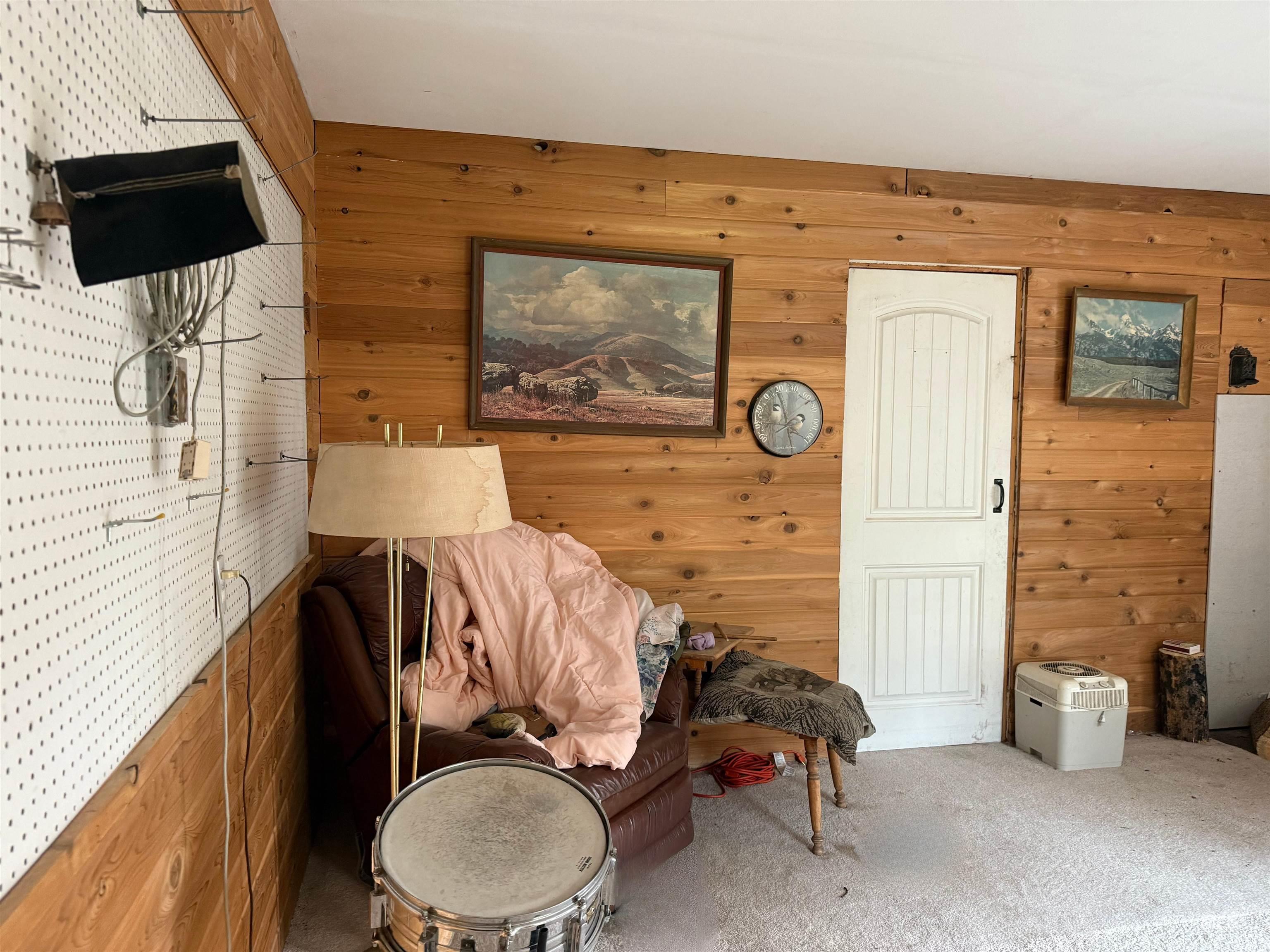 140 Ridgeway Drive Elk City, ID 83525 - Photo 45 of 47 Sitting room featuring wooden walls and carpet