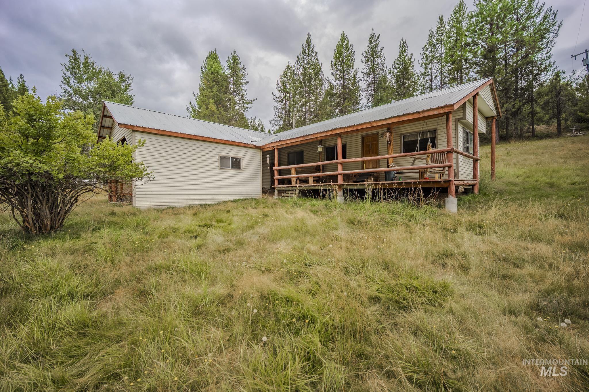 140 Ridgeway Drive Elk City, ID 83525 - Photo 9 of 47 Rear view of house featuring a metal roof and a wooden deck