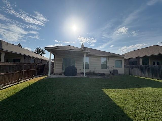 14308 Polo Ranch Street Fort Worth, TX 76052 - Photo 19 of 19 Spacious backyard featuring an extended patio with an overhead roof structure, a lush green lawn, and a full privacy fence