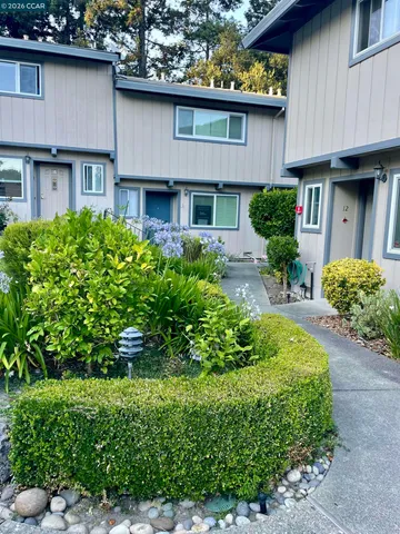 a front view of a house with a yard garage and outdoor seating