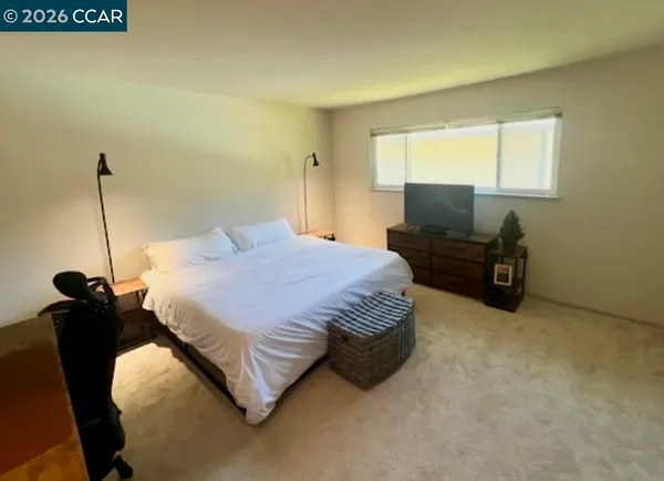a bedroom with a bed and dresser