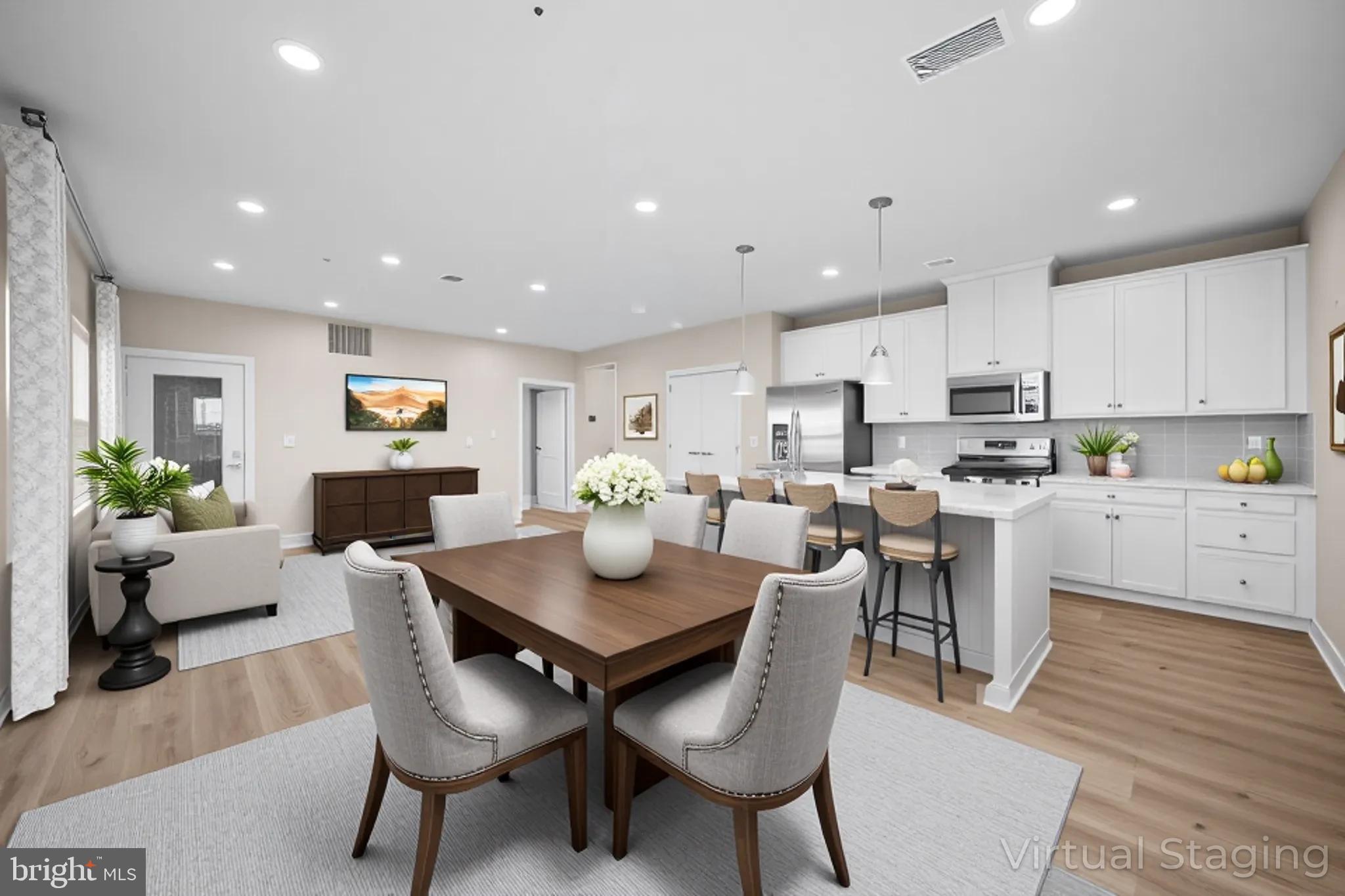 a view of kitchen with cabinets table and chairs