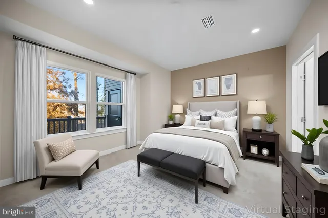 a bedroom with a bed a couch and a large window