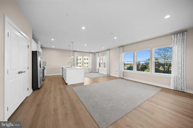 a view of a living room a window and wooden floor