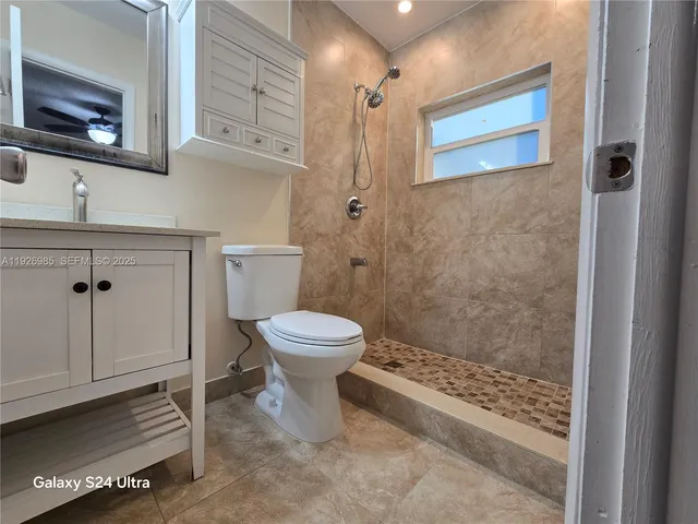 a bathroom with a toilet sink and shower
