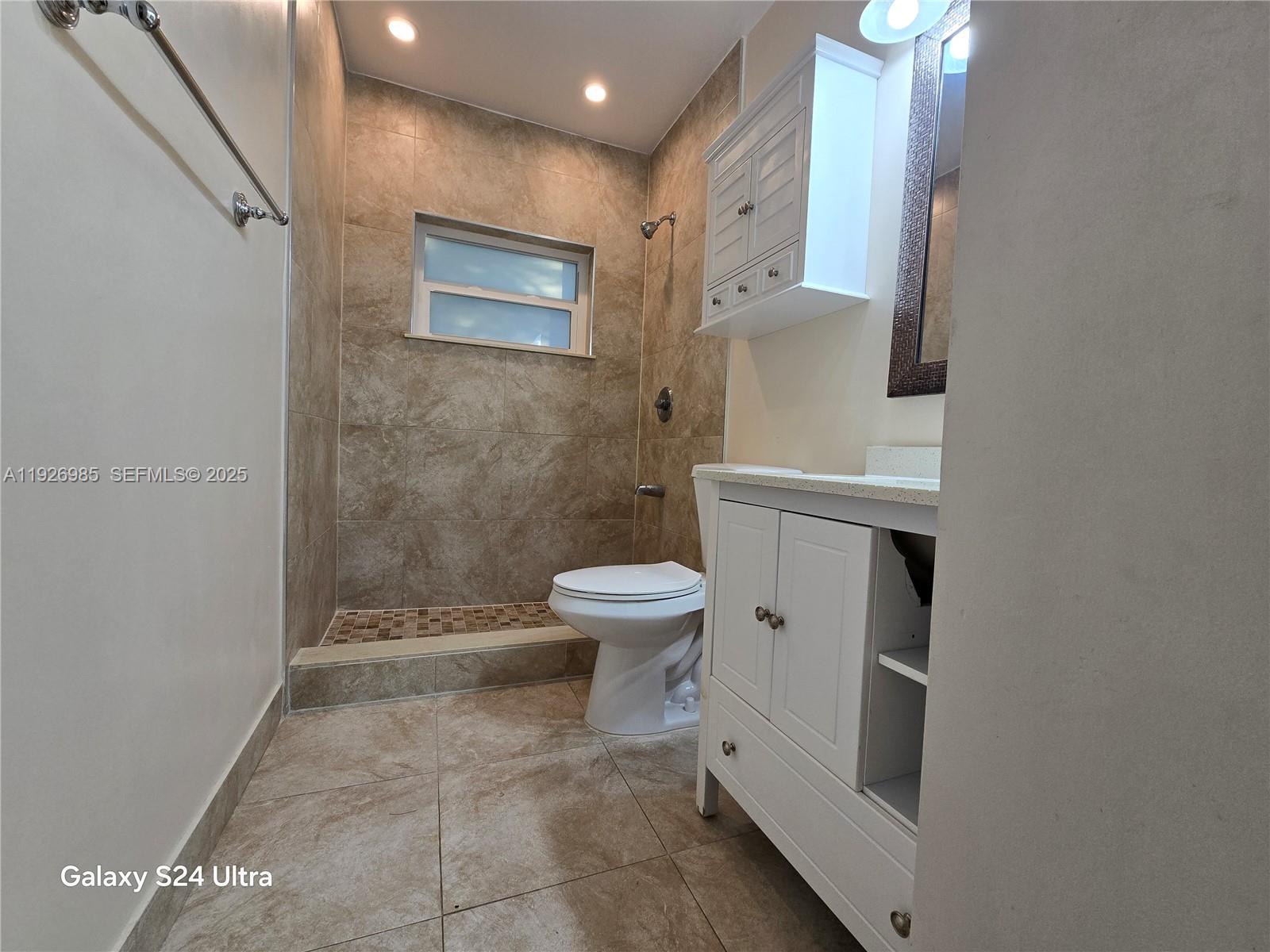 12364 Southwest 266th Terrace, Unit 12364 Homestead, FL 33032 - Photo 16 of 32 a bathroom with a toilet sink and shower
