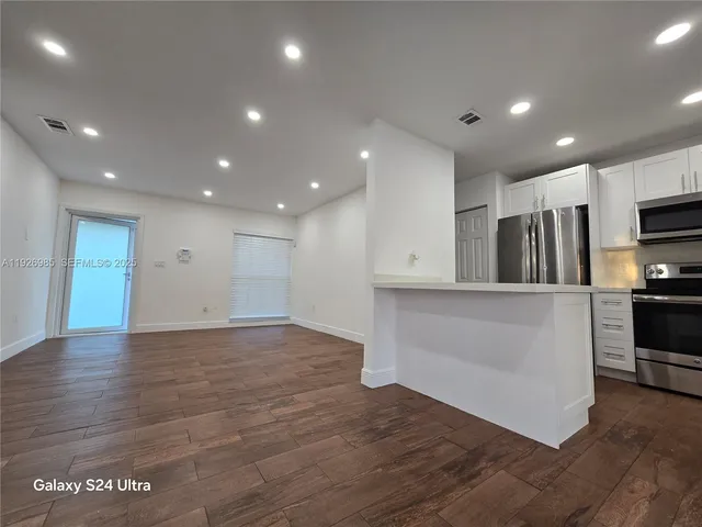 a view of kitchen with wooden floor