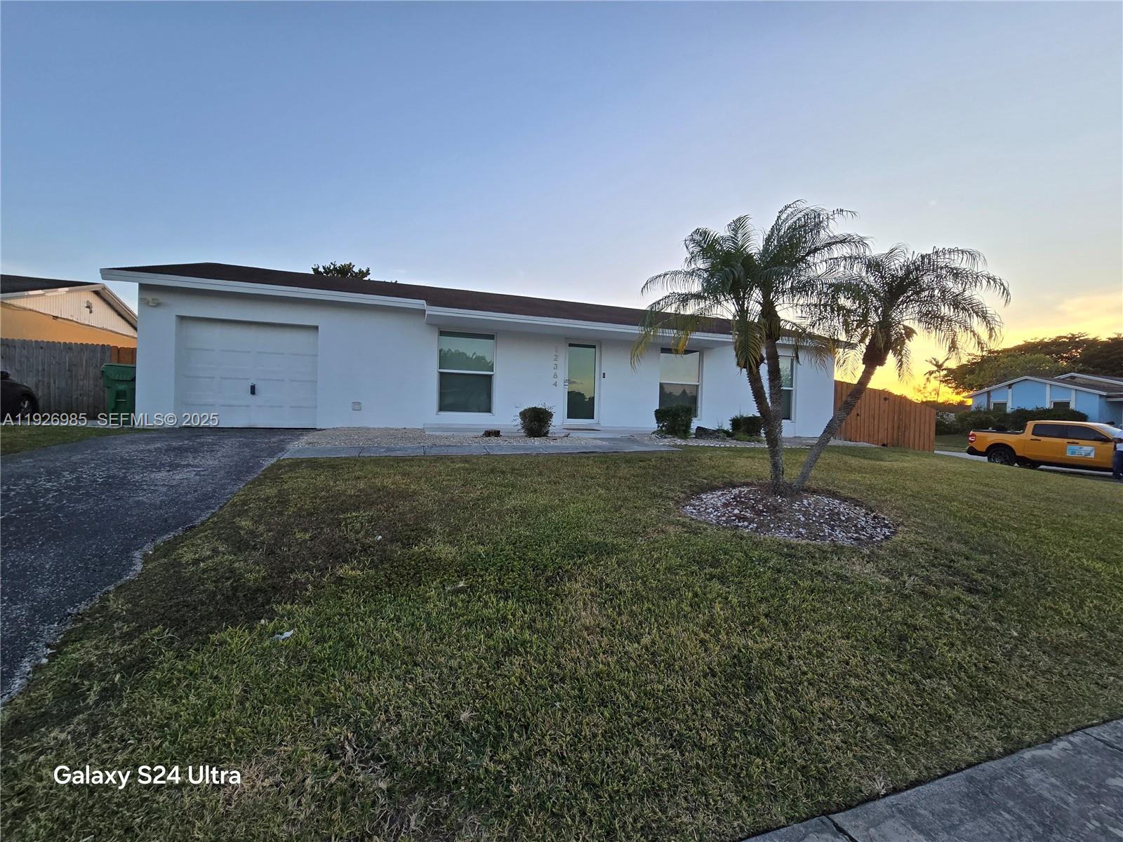 12364 Southwest 266th Terrace, Unit 12364 Homestead, FL 33032 - Photo 21 of 32 a house view with a garden space