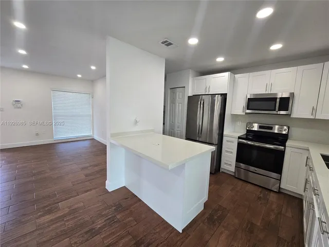 a view of a hallway with washer and dryer