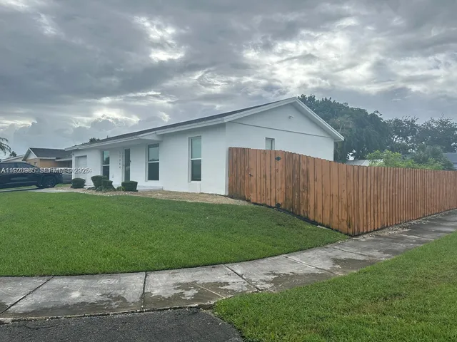 a view of a backyard with plants and a garden