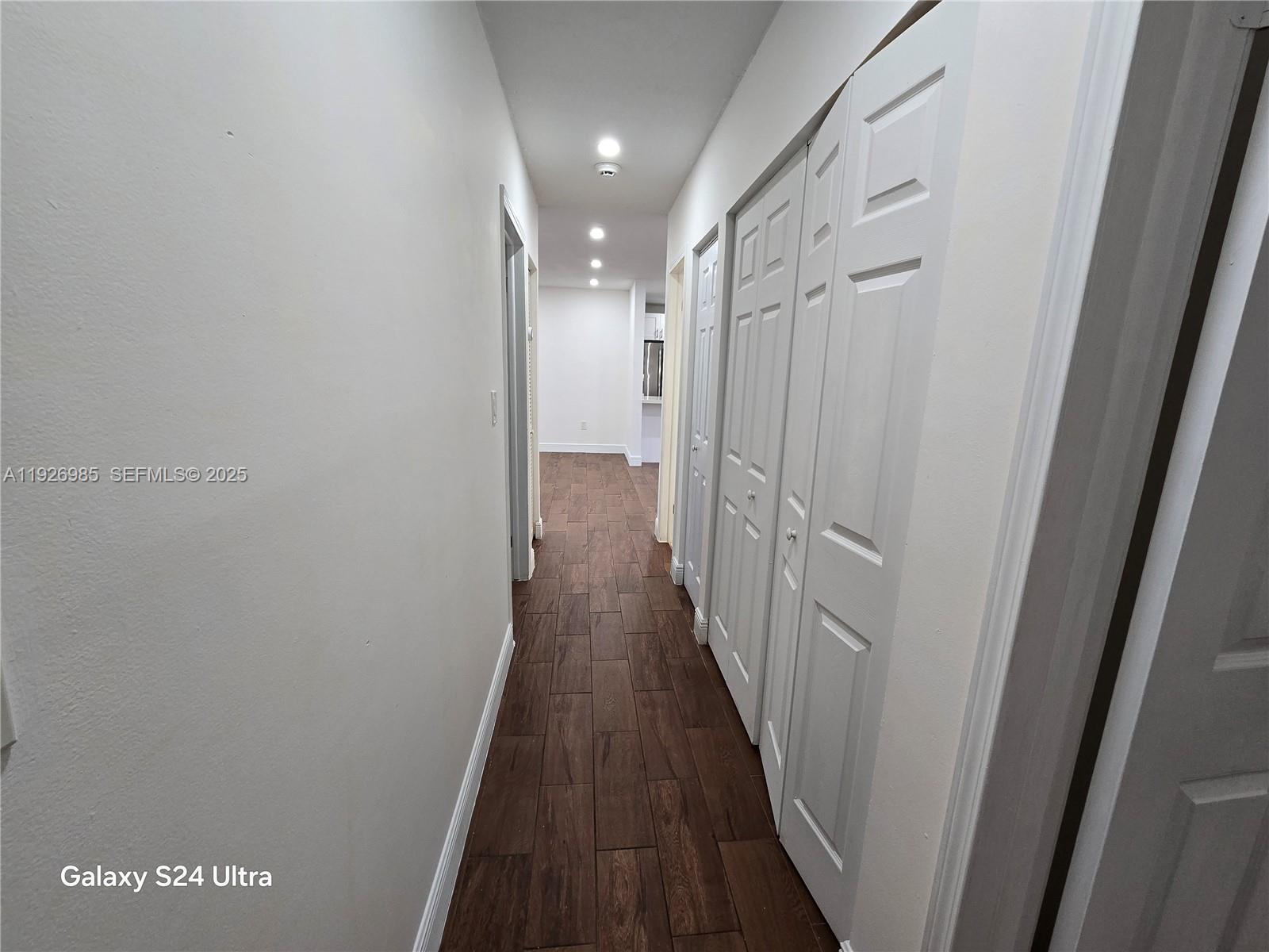 12364 Southwest 266th Terrace, Unit 12364 Homestead, FL 33032 - Photo 10 of 32 a view of a hallway with wooden floor
