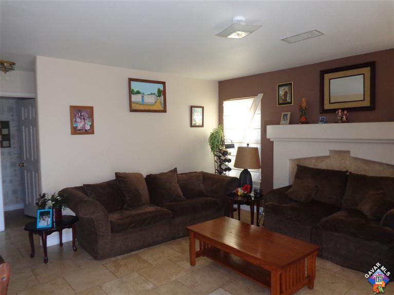 37929 Tackstem Street Palmdale, CA 93552 - Photo 4 of 8 a living room with furniture a flat screen tv and a fireplace