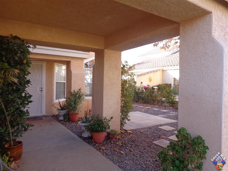 37929 Tackstem Street Palmdale, CA 93552 - Photo 6 of 8 a view of a porch with plants and a potted plant