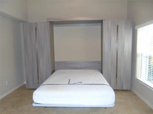 a view of an empty room with bathroom and a bathroom