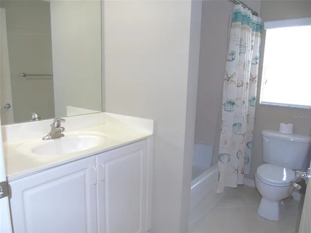 a bathroom with a toilet sink and shower