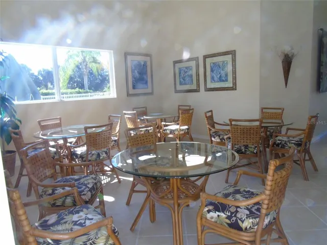 a view of backyard with swimming pool and seating