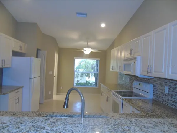a kitchen with granite countertop a stove a sink and a granite counter tops