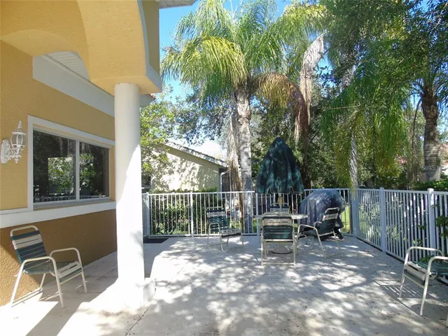 a view of a chairs and table in patio