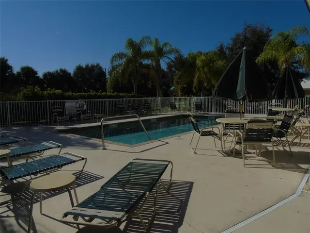 a view of a house with backyard water fountain and sitting area