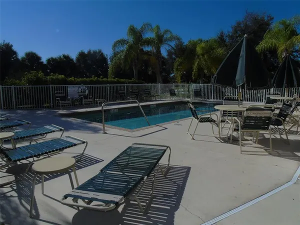 a house view with a sitting space fire pit and outdoor space