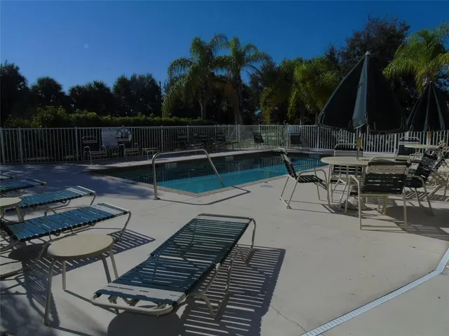 a house view with a sitting space fire pit and outdoor space