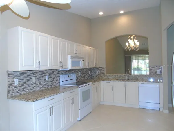 a bathroom with a granite countertop sink and vanity