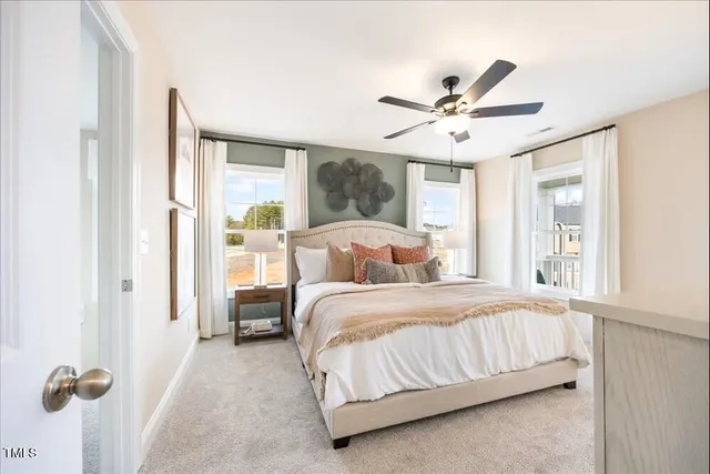 a bedroom with a bed and a large window