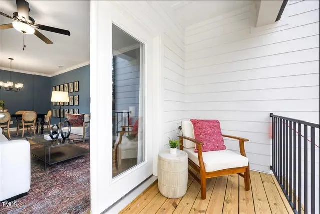 a living room with furniture a rug and white walls