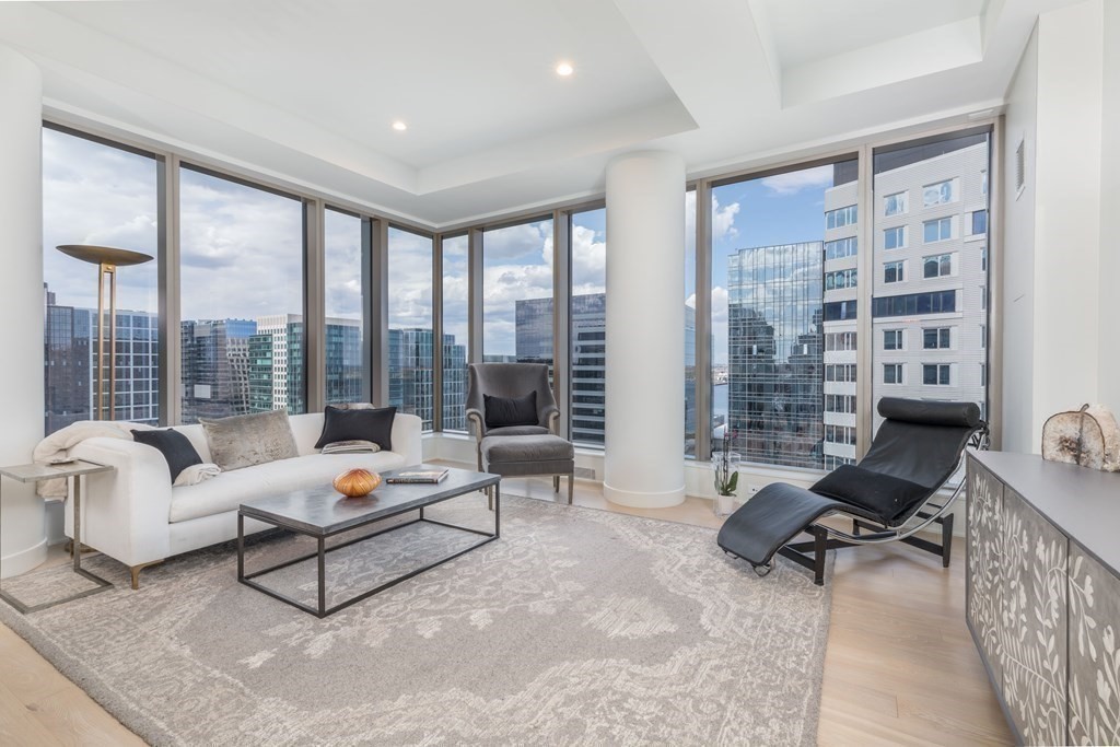 a living room with furniture and a floor to ceiling window