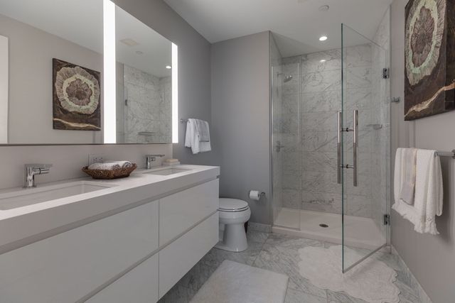 a bathroom with a toilet sink and shower