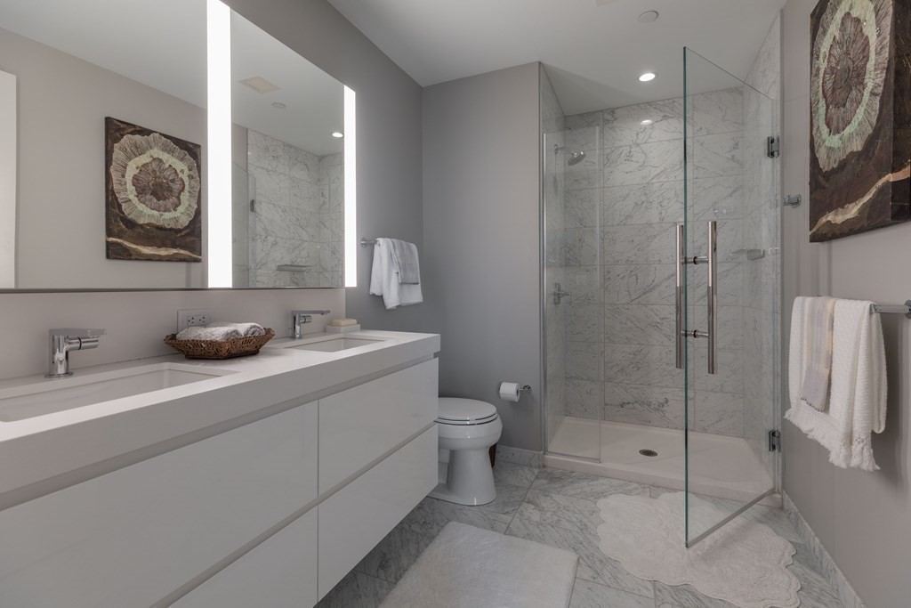 133 Seaport Boulevard, Unit 1908 Boston, MA 02210 - Photo 14 of 34 a bathroom with a toilet sink and shower