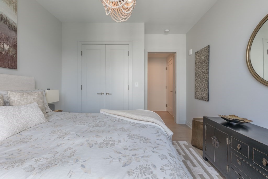 133 Seaport Boulevard, Unit 1908 Boston, MA 02210 - Photo 16 of 34 a bedroom with a bed and a tv on the dresser