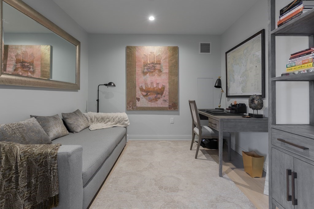 133 Seaport Boulevard, Unit 1908 Boston, MA 02210 - Photo 19 of 34 a living room with furniture a desk and chair