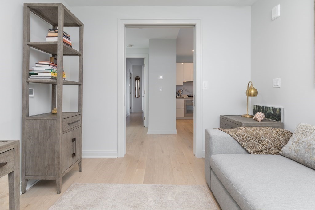 133 Seaport Boulevard, Unit 1908 Boston, MA 02210 - Photo 20 of 34 a living room with furniture and a chandelier