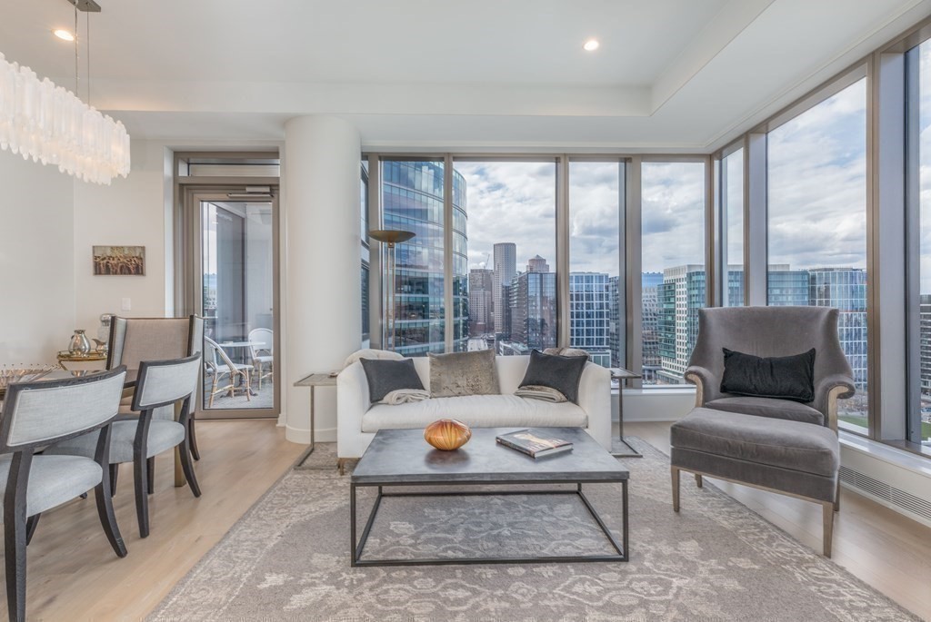 133 Seaport Boulevard, Unit 1908 Boston, MA 02210 - Photo 3 of 34 a living room with furniture and a large window