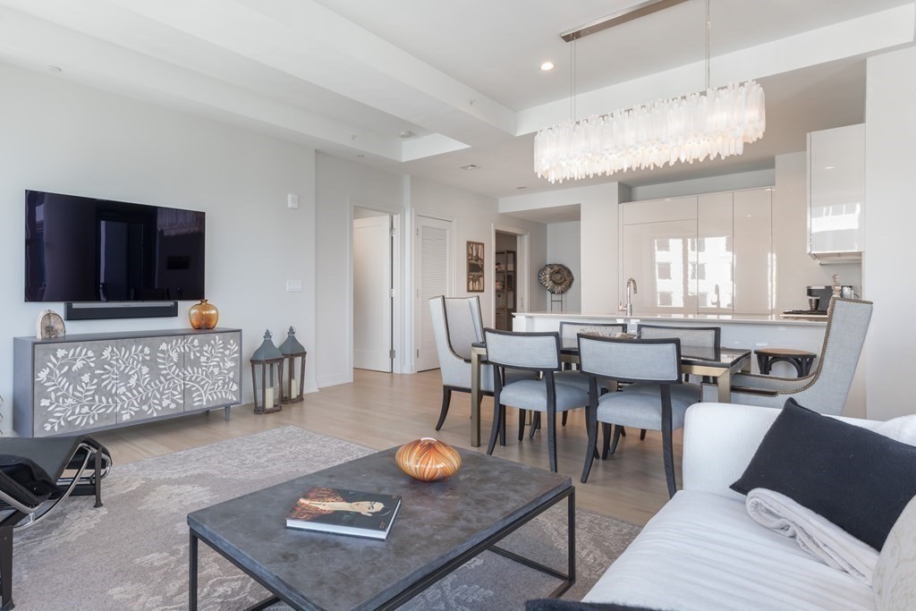 133 Seaport Boulevard, Unit 1908 Boston, MA 02210 - Photo 9 of 34 a living room with furniture and a flat screen tv