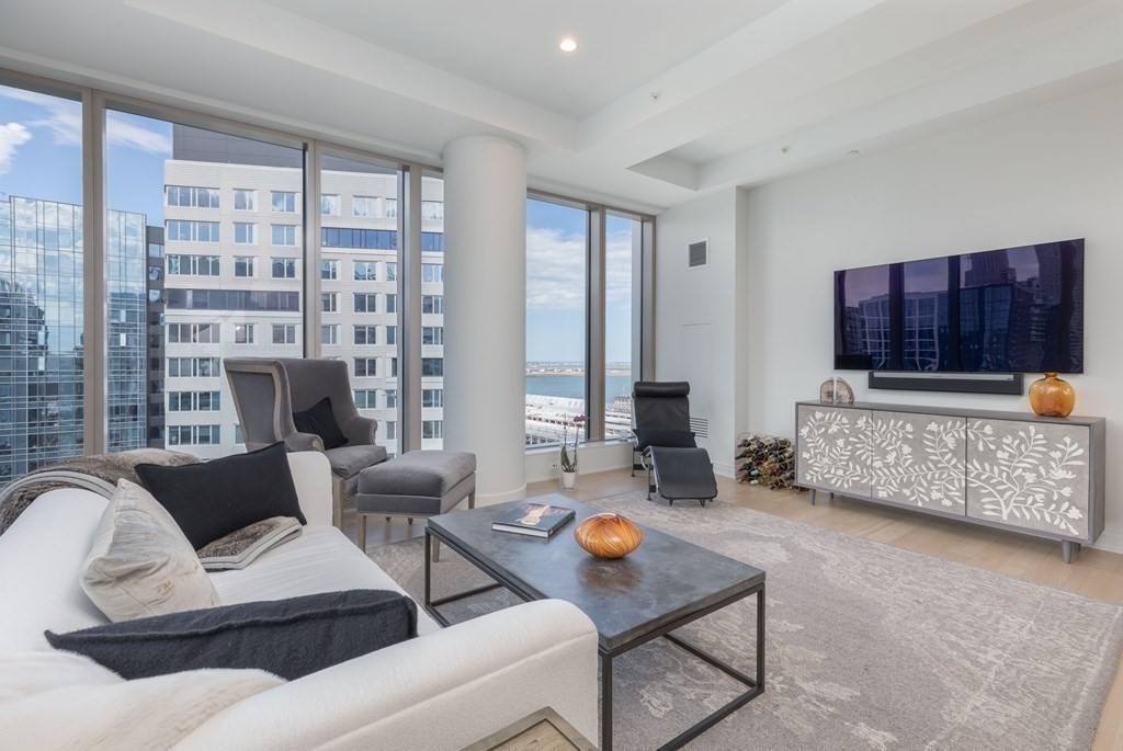 133 Seaport Boulevard, Unit 1908 Boston, MA 02210 - Photo 10 of 34 a living room with furniture and a fireplace