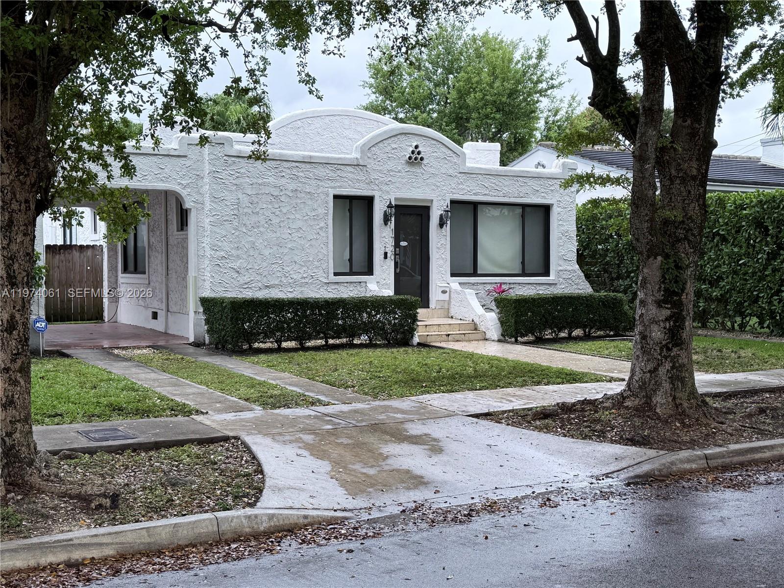 1720 Southwest 22nd Terrace Miami, FL 33145 - Photo 1 of 19 a front view of a house with a yard and a garage