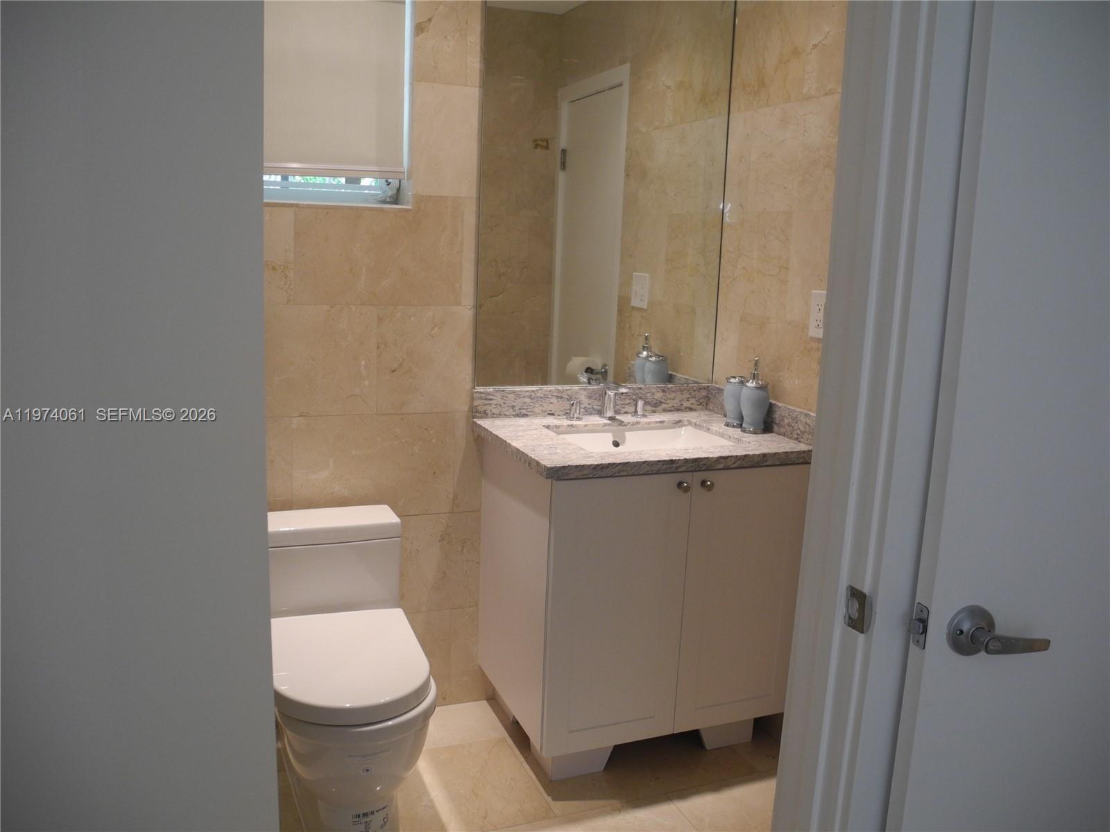1720 Southwest 22nd Terrace Miami, FL 33145 - Photo 11 of 19 a bathroom with a sink a toilet and mirror