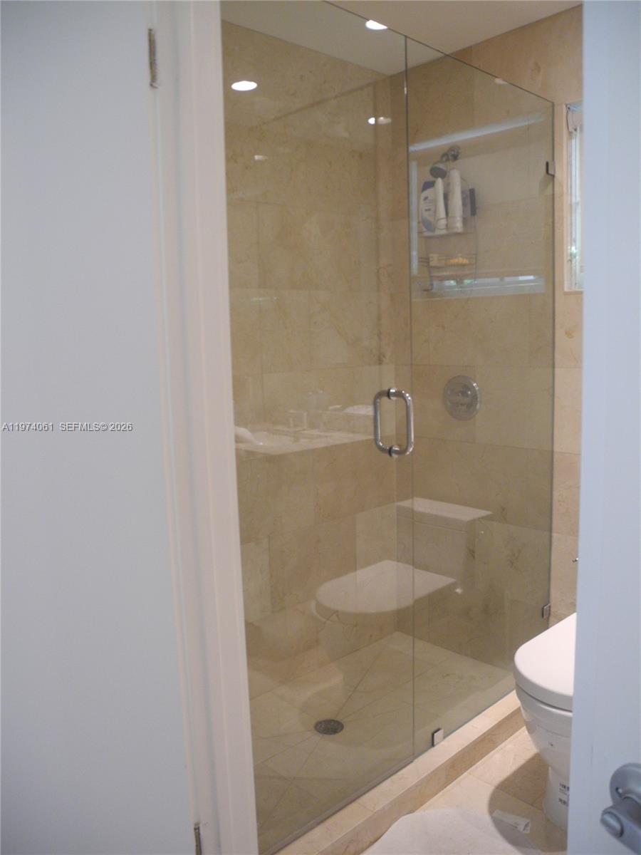 1720 Southwest 22nd Terrace Miami, FL 33145 - Photo 13 of 19 a bathroom with a shower a toilet and a sink