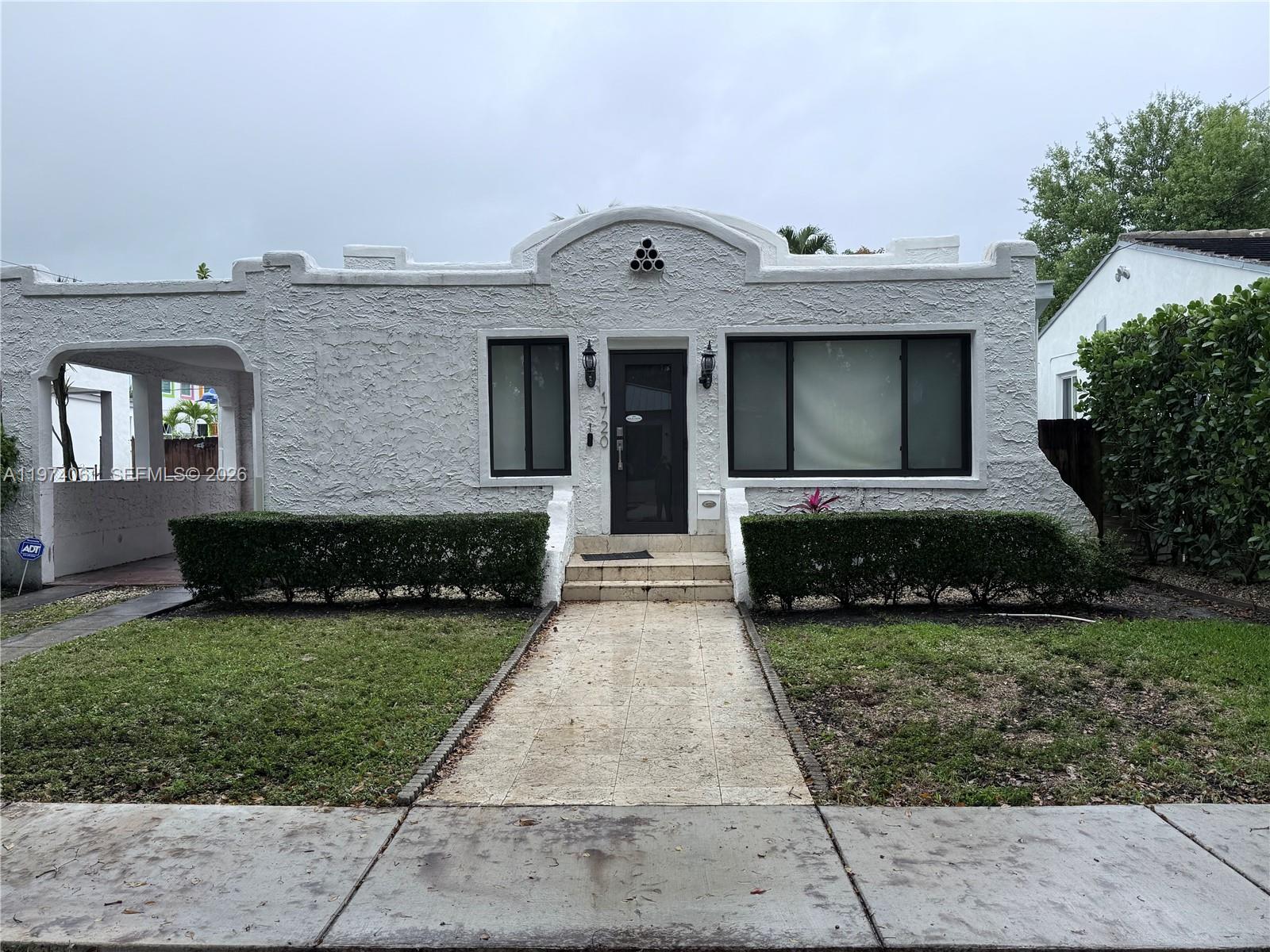 1720 Southwest 22nd Terrace Miami, FL 33145 - Photo 3 of 19 a front view of a house with a yard